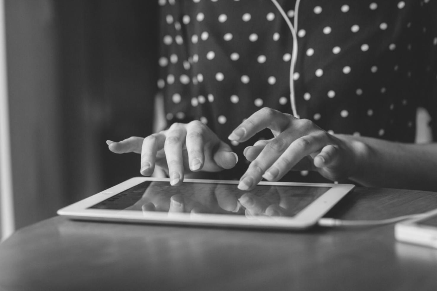 Person reviewing financial spreadsheet on laptop with documents and calculator nearby